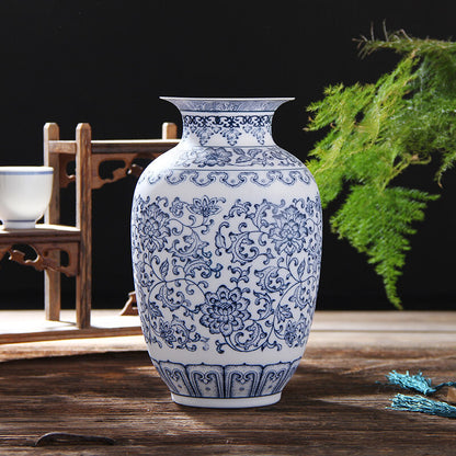 Blue and white floral-patterned vase on a wooden surface with a dark background