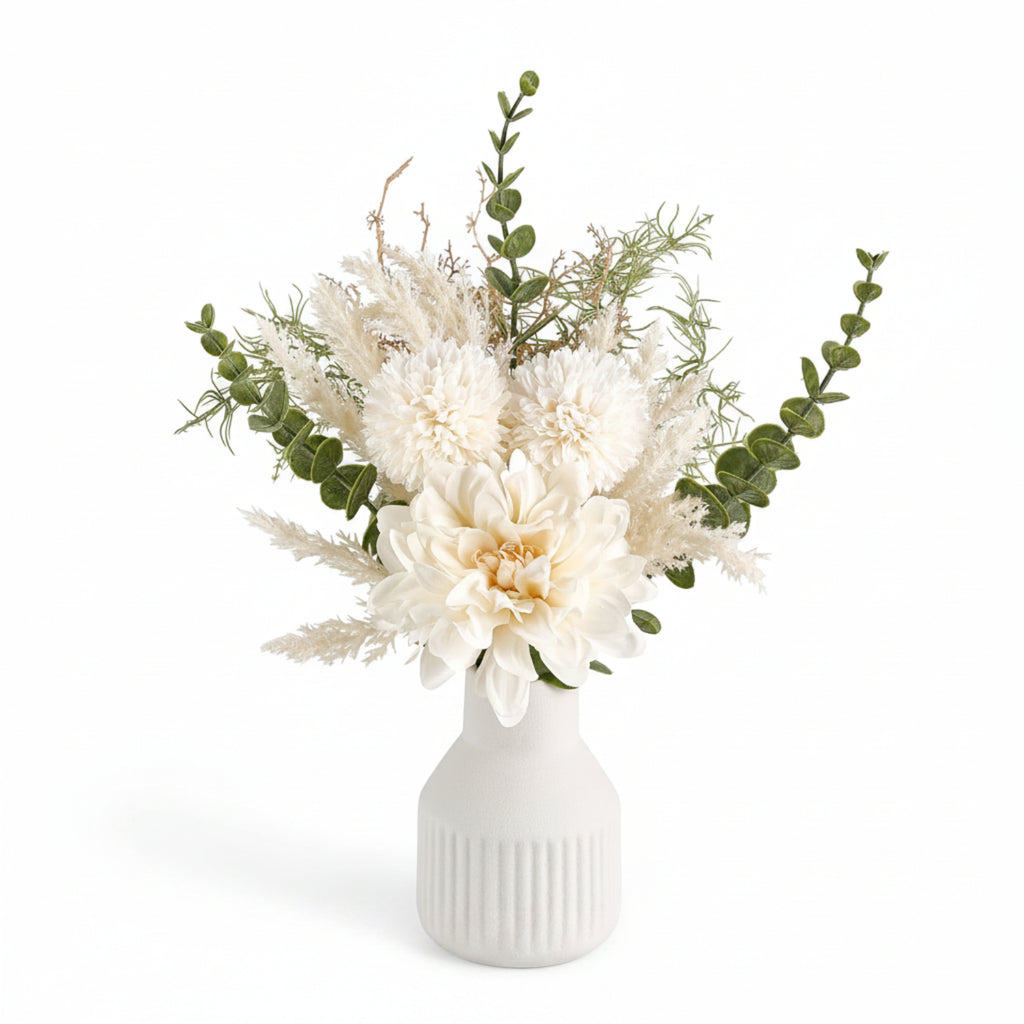 Floral arrangement with white flowers and greenery in a white vase on a white background